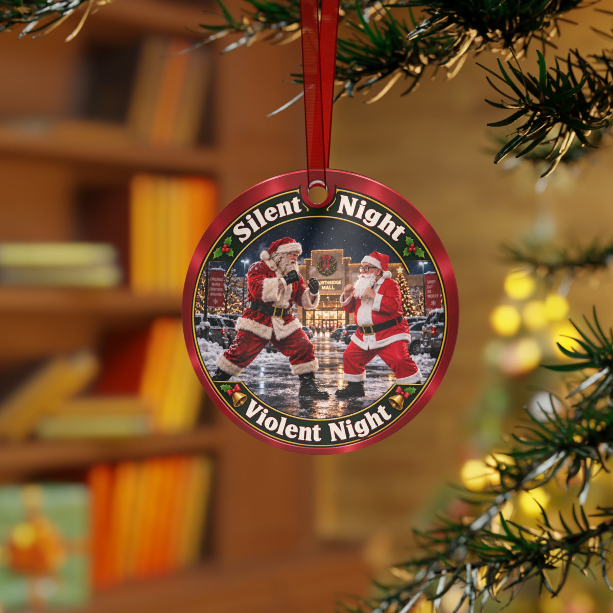 "Silent Night, Violent Night" metal ornament hanging on a Christmas tree branch with a blurred bookshelf behind it